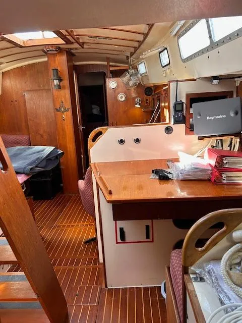 Slide: The Image of Interior of 1984 Whitby 42 Ketch sailboat with wooden furnishings and navigation equipment. - 29