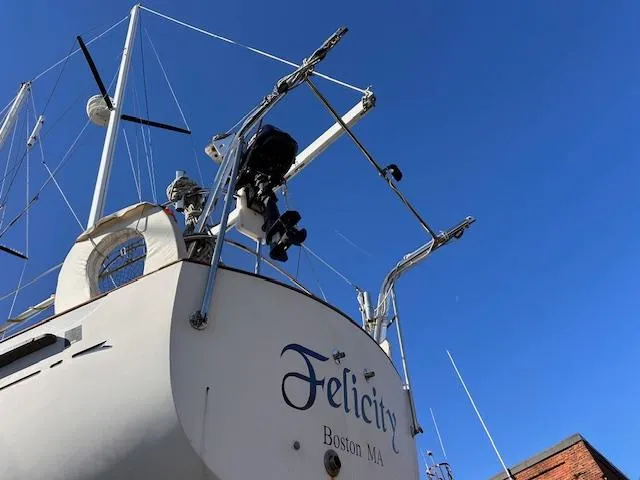 Slide: The Image of 1984 Whitby 42 Ketch sailboat named "Felicity" docked in Boston, MA against clear blue sky. - 3