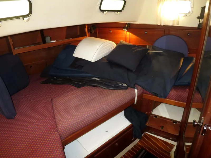 Slide: The Image of Cozy cabin interior of 1984 Whitby 42 Ketch with comfortable bedding and wooden furnishings. - 30