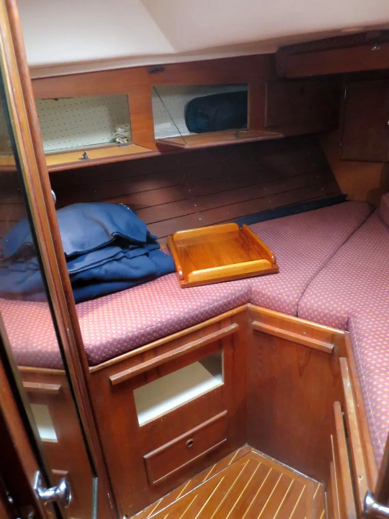 Slide: The Image of Cozy cabin interior of 1984 Whitby 42 Ketch with wooden furnishings and bedding. - 31