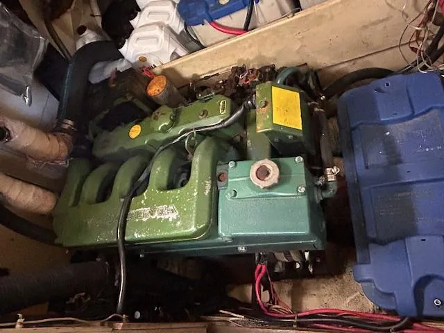 Slide: The Image of Engine compartment of a 1984 Whitby 42 Ketch sailboat, featuring a green marine engine. - 34