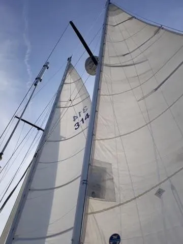Slide: The Image of Sails of a 1984 Whitby 42 Ketch against a clear blue sky. - 36