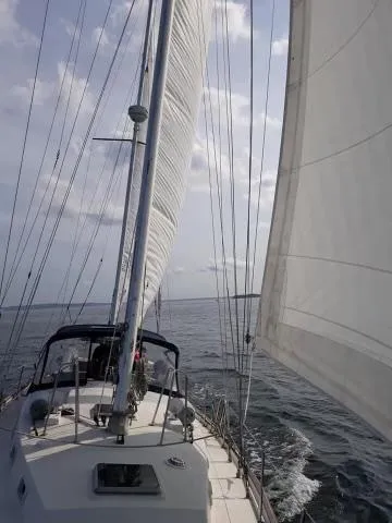 Slide: The Image of Sailing on a 1984 Whitby 42 Ketch with full sails on open water. - 37