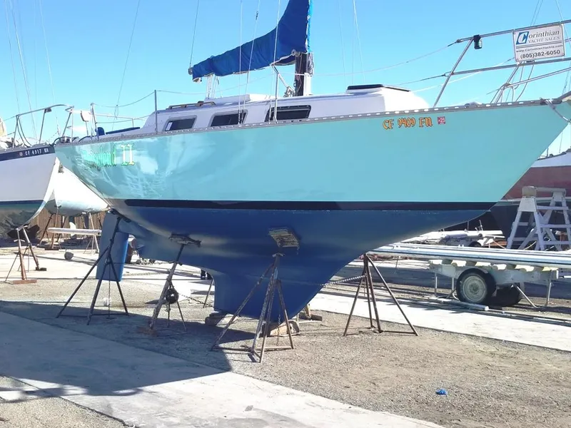 The Image of 1977 Columbia 8.7 sailboat on stands, blue hull, marina setting. - 2