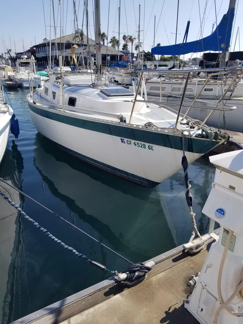 The Image of 1979 Columbia 9.6 sailboat docked in a marina, surrounded by other boats. - 1