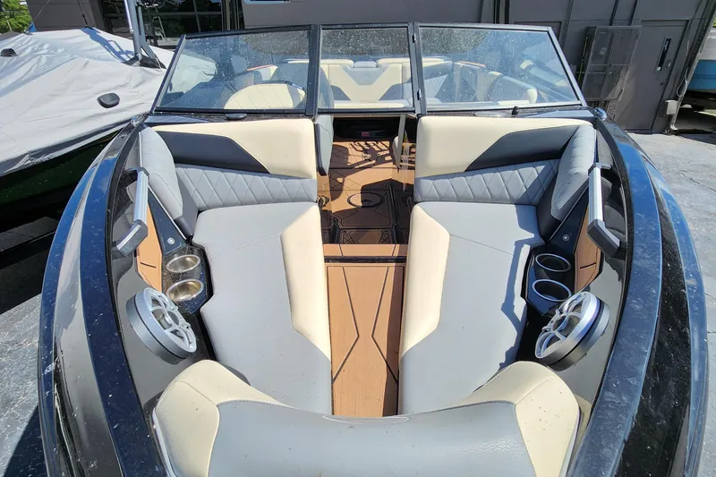 Slide: The Image of 2022 Tigé Z1 boat interior with beige seating and cup holders. - 11
