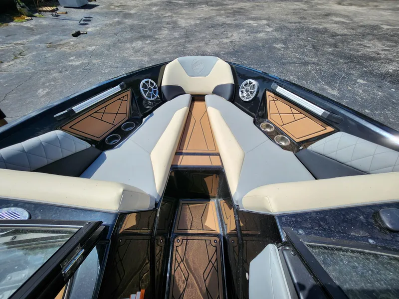 Slide: The Image of 2022 Tigé Z1 boat interior with beige and gray seating, cup holders, and speakers. - 9
