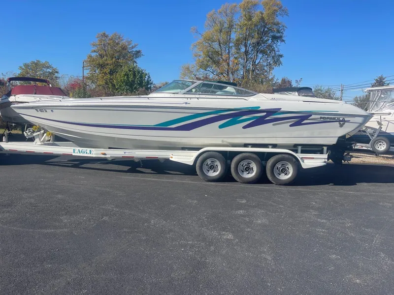 Slide: The Image of 1998 Formula 312FASTECH boat on trailer, parked outdoors, clear day. - 1