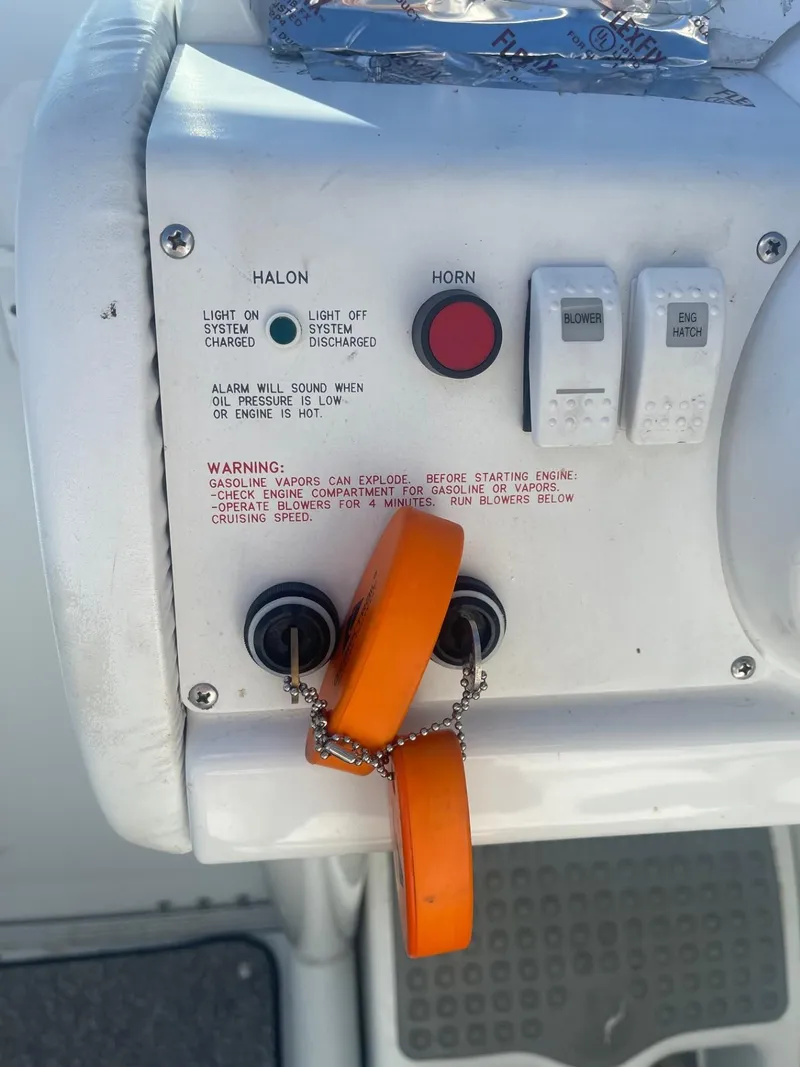 Slide: The Image of Control panel of a 1998 Formula 312FASTECH boat with safety switches and warning labels. - 10