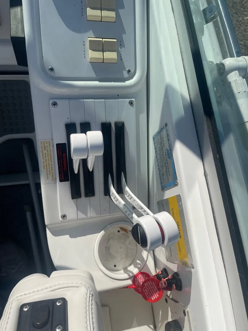 Slide: The Image of Control panel of a 1998 Formula 312FASTECH boat with throttle levers and switches. - 15