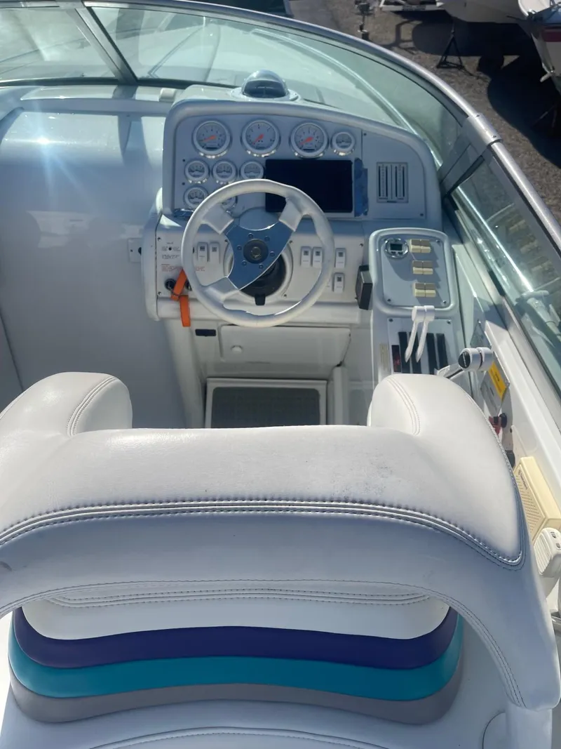 Slide: The Image of 1998 Formula 312FASTECH boat cockpit with steering wheel and dashboard controls. - 8