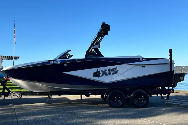 Slide: The Image of 2024 Axis T 220 boat on trailer by waterfront, clear blue sky. - 10
