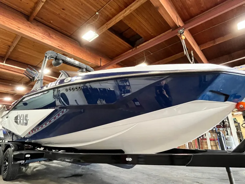 Slide: The Image of 2024 Axis T 220 boat in a wooden ceiling showroom. - 7