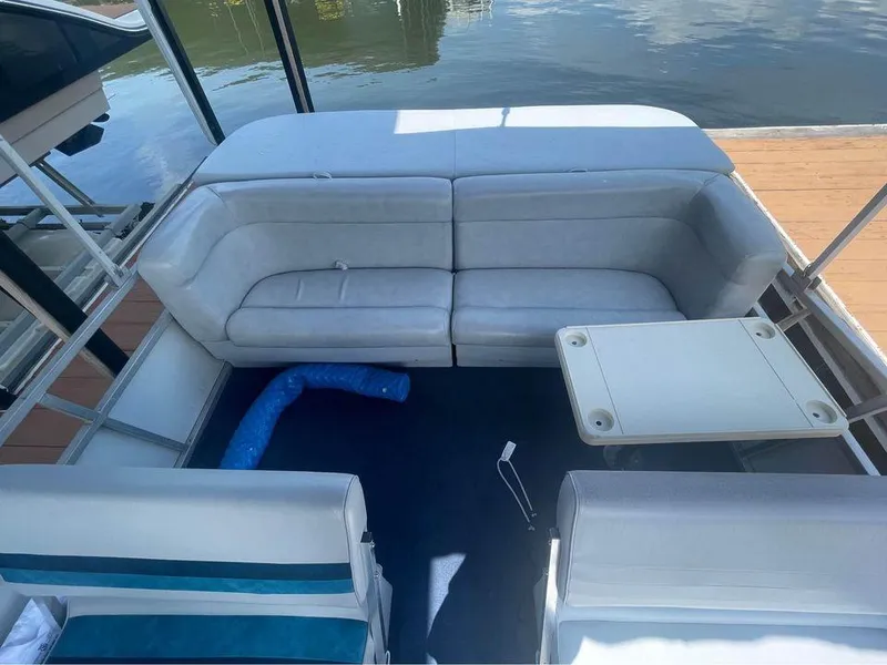 Slide: The Image of 1994 Alumaweld Getaway boat interior with white seating and small table. - 6