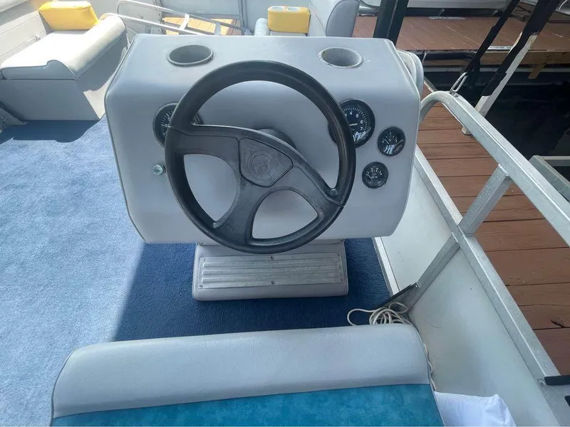 Slide: The Image of 1994 Alumaweld Getaway boat steering console with gauges and seating. - 7
