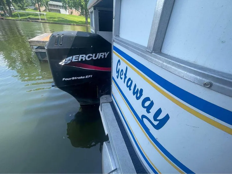 Slide: The Image of 1994 Alumaweld Getaway boat with Mercury FourStroke EFI engine on a calm lake. - 9