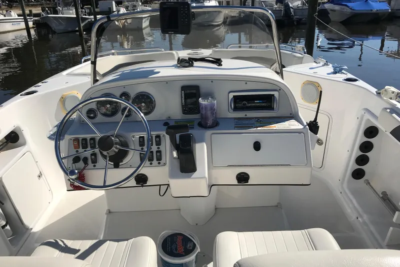 Slide: The Image of 2014 Hurricane SunDeck Sport 231 OB boat cockpit with steering wheel and control panel. - 7