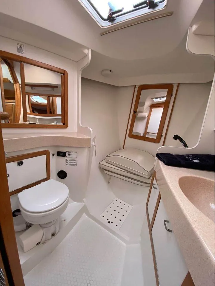 Slide: The Image of 1998 Catalina 42 MkII yacht bathroom with modern fixtures and wood accents. - 7