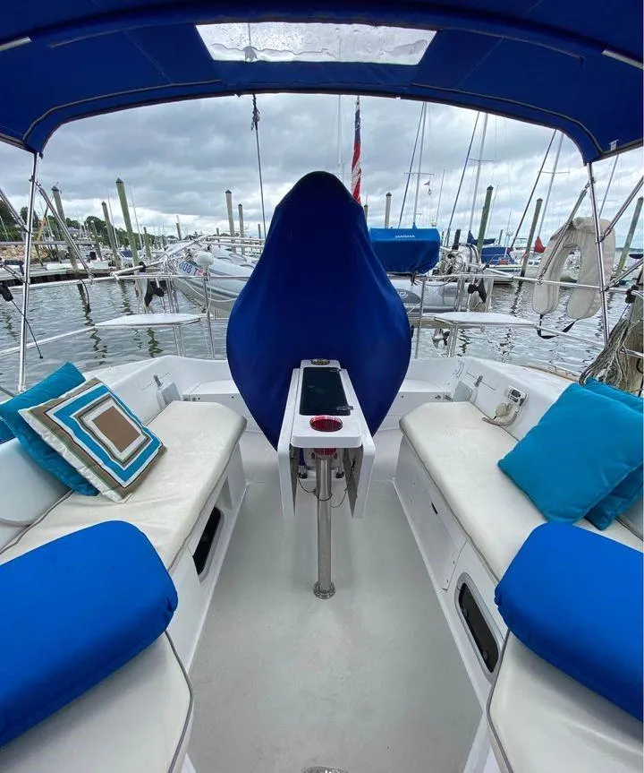 Slide: The Image of 1998 Catalina 42 MkII sailboat cockpit with blue cushions and marina view. - 8