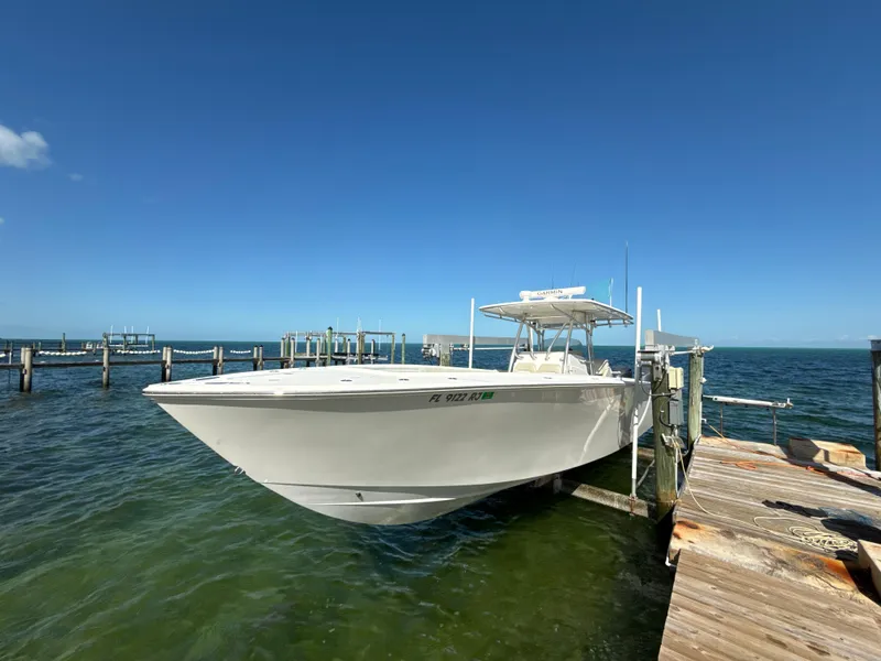 Slide: The Image of 2008 Jupiter 38 boat docked on clear blue water under a sunny sky. - 0