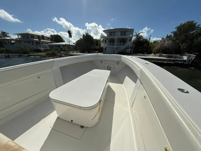 Slide: The Image of 2008 Jupiter 38 boat interior with seating, docked near waterfront homes. - 14