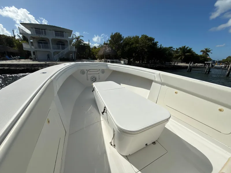 Slide: The Image of 2008 Jupiter 38 boat interior with seating, docked near waterfront property. - 15