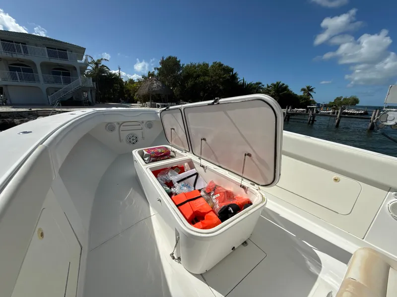 Slide: The Image of Open storage compartment on 2008 Jupiter 38 boat, docked near waterfront property. - 16