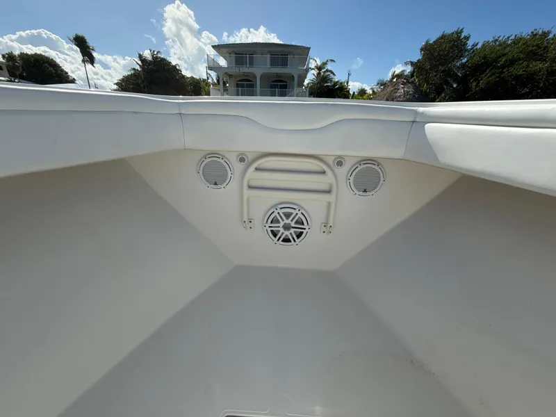 Slide: The Image of 2008 Jupiter 38 boat interior with speakers, clear sky, and house in background. - 17