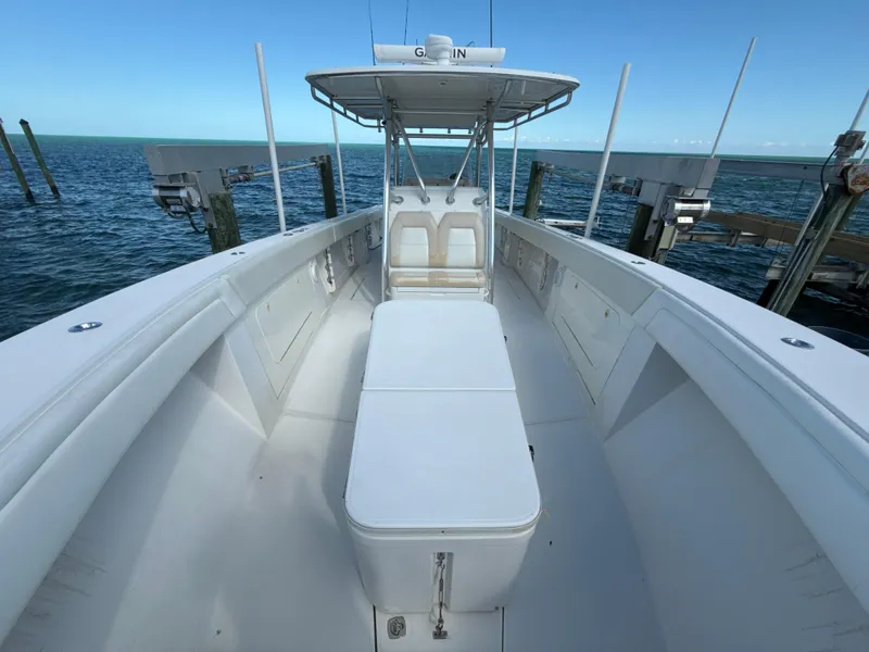 Slide: The Image of 2008 Jupiter 38 boat docked by the ocean, featuring spacious deck and seating. - 19