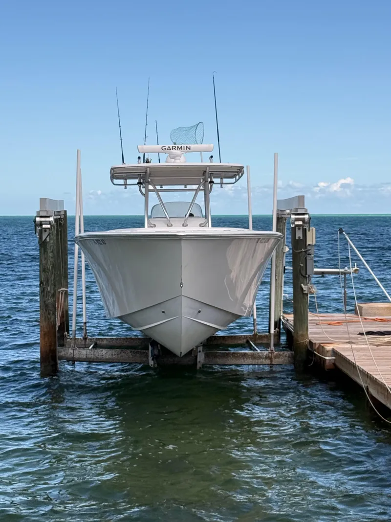 Slide: The Image of 2008 Jupiter 38 boat docked on lift, ocean background. - 2