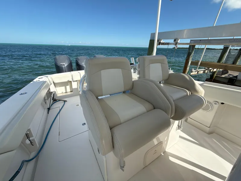 Slide: The Image of 2008 Jupiter 38 boat interior with dual seats, ocean view, and dock. - 24