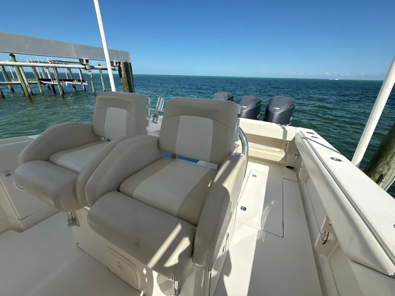 Slide: The Image of 2008 Jupiter 38 boat with dual seats, ocean view, and outboard motors. - 25