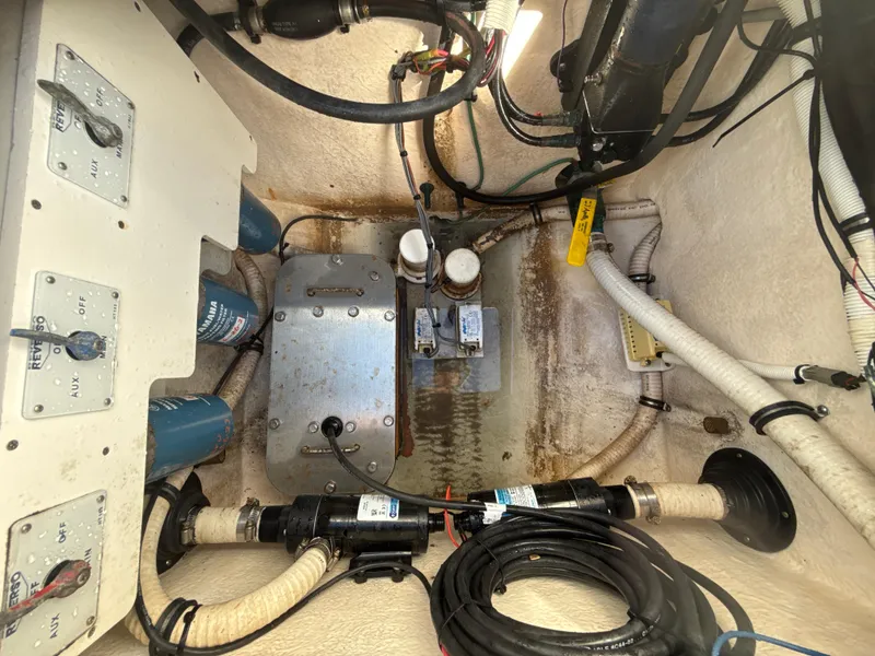 Slide: The Image of Engine compartment of a 2008 Jupiter 38 boat, showing wiring and mechanical components. - 28