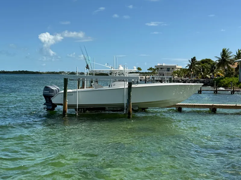 Slide: The Image of 2008 Jupiter 38 boat docked on clear, sunny waters with palm trees in the background. - 3