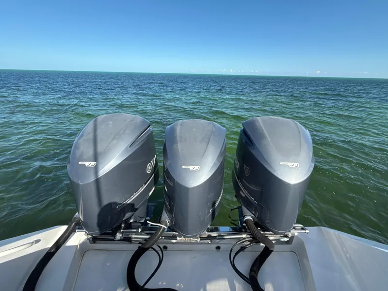 Slide: The Image of Triple outboard motors on a 2008 Jupiter 38 boat, ocean view. - 5