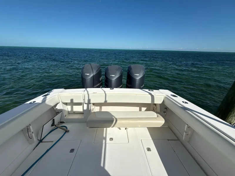 Slide: The Image of 2008 Jupiter 38 boat with triple outboard motors on open sea. - 7