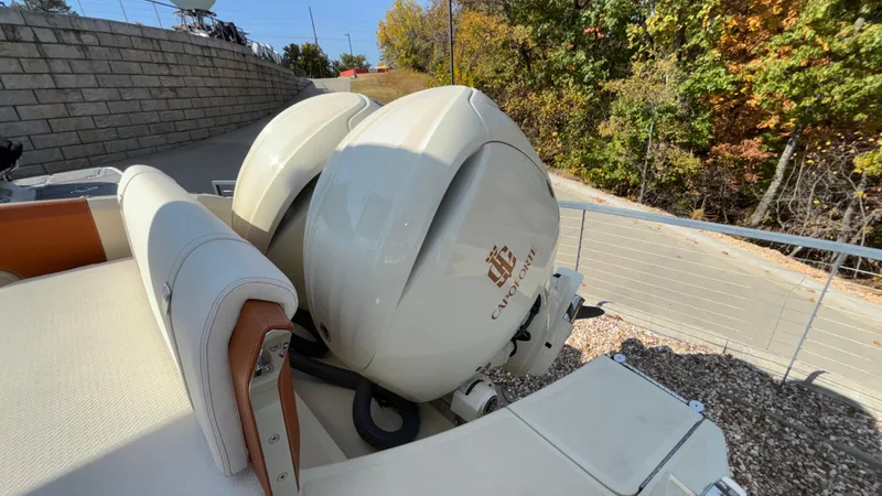 Slide: The Image of 2024 Capoforte FX270 boat with dual engines, outdoor setting, autumn foliage. - 11