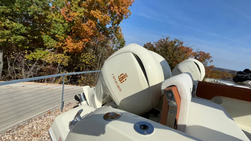 Slide: The Image of 2024 Capoforte FX270 boat with dual engines, autumn trees in the background. - 14