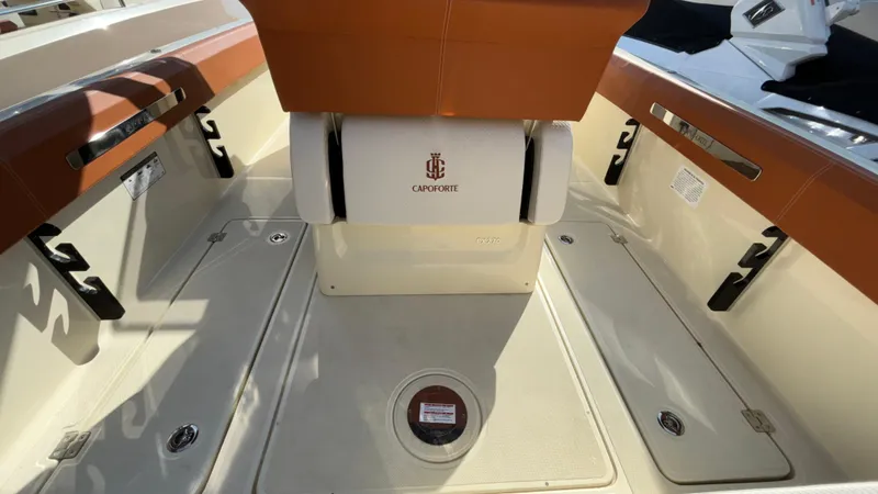 Slide: The Image of 2024 Capoforte FX270 boat interior with sleek seating and storage compartments. - 16