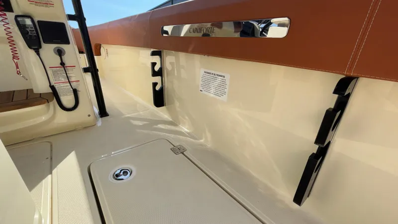 Slide: The Image of 2024 Capoforte FX270 boat interior with beige and brown accents. - 18
