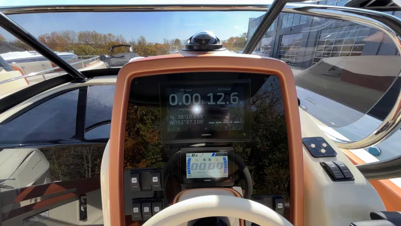 Slide: The Image of 2024 Capoforte FX270 boat dashboard with digital display and controls. - 23