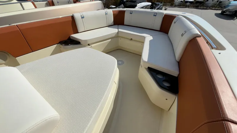 Slide: The Image of 2024 Capoforte FX270 boat interior with luxurious seating and cup holders. - 25