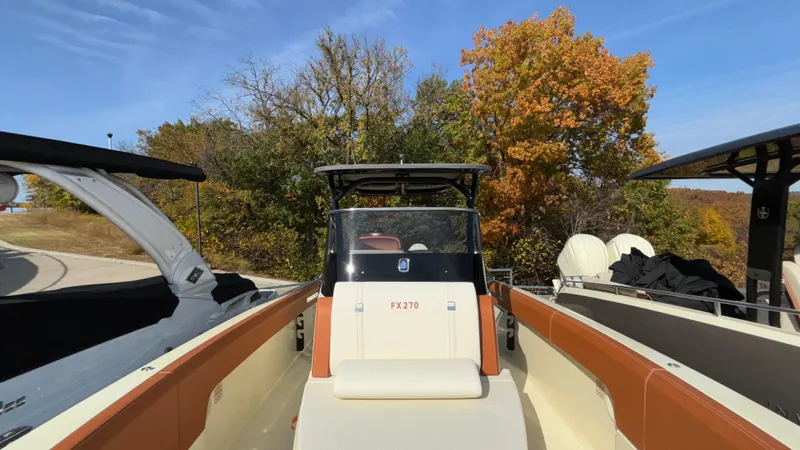 Slide: The Image of 2024 Capoforte FX270 boat with autumn trees in the background. - 27