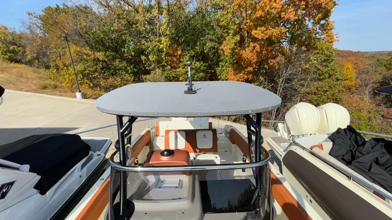 Slide: The Image of 2024 Capoforte FX270 boat with canopy, docked near autumn trees. - 29