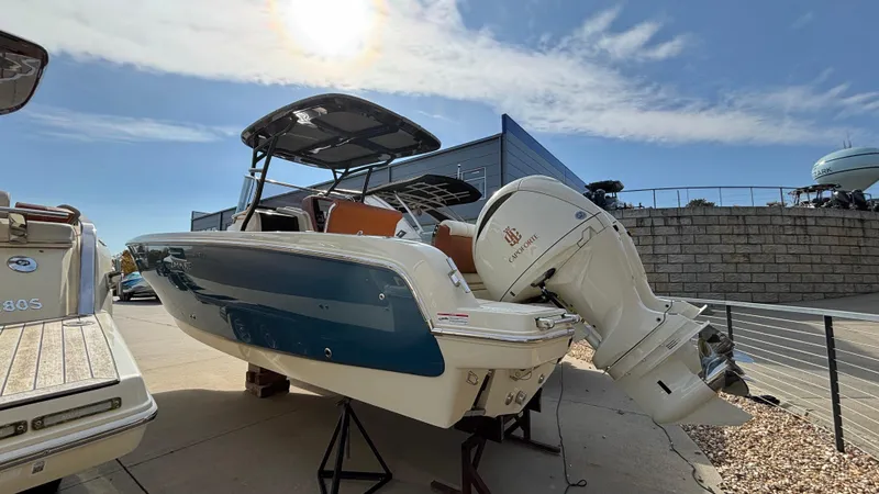 Slide: The Image of 2024 Capoforte FX270 boat with outboard motor, displayed outdoors under a sunny sky. - 3