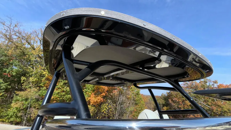 Slide: The Image of 2024 Capoforte FX270 boat canopy against a clear blue sky and autumn trees. - 30