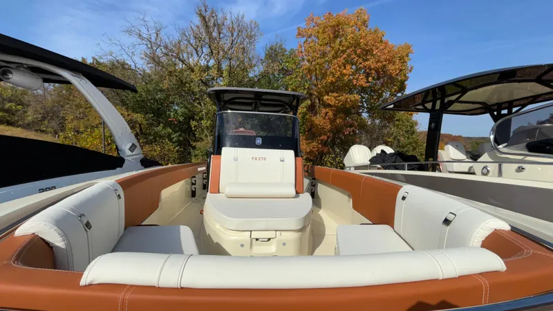 Slide: The Image of 2024 Capoforte FX270 boat with luxurious seating, docked outdoors. - 38