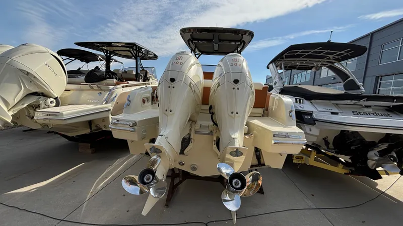 Slide: The Image of 2024 Capoforte FX270 boats with dual outboard engines in a marina setting. - 4