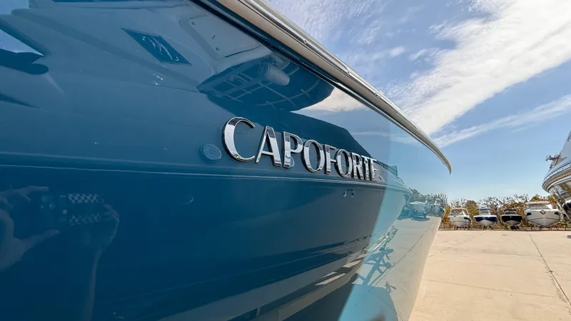 Slide: The Image of 2024 Capoforte FX270 boat, blue hull, outdoor display. - 7