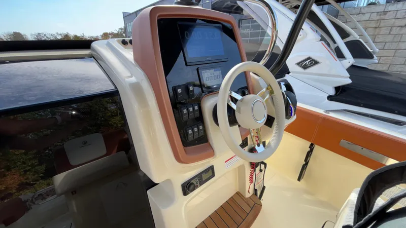 Slide: The Image of 2024 Capoforte FX270 boat cockpit with modern steering and control panel. - 8